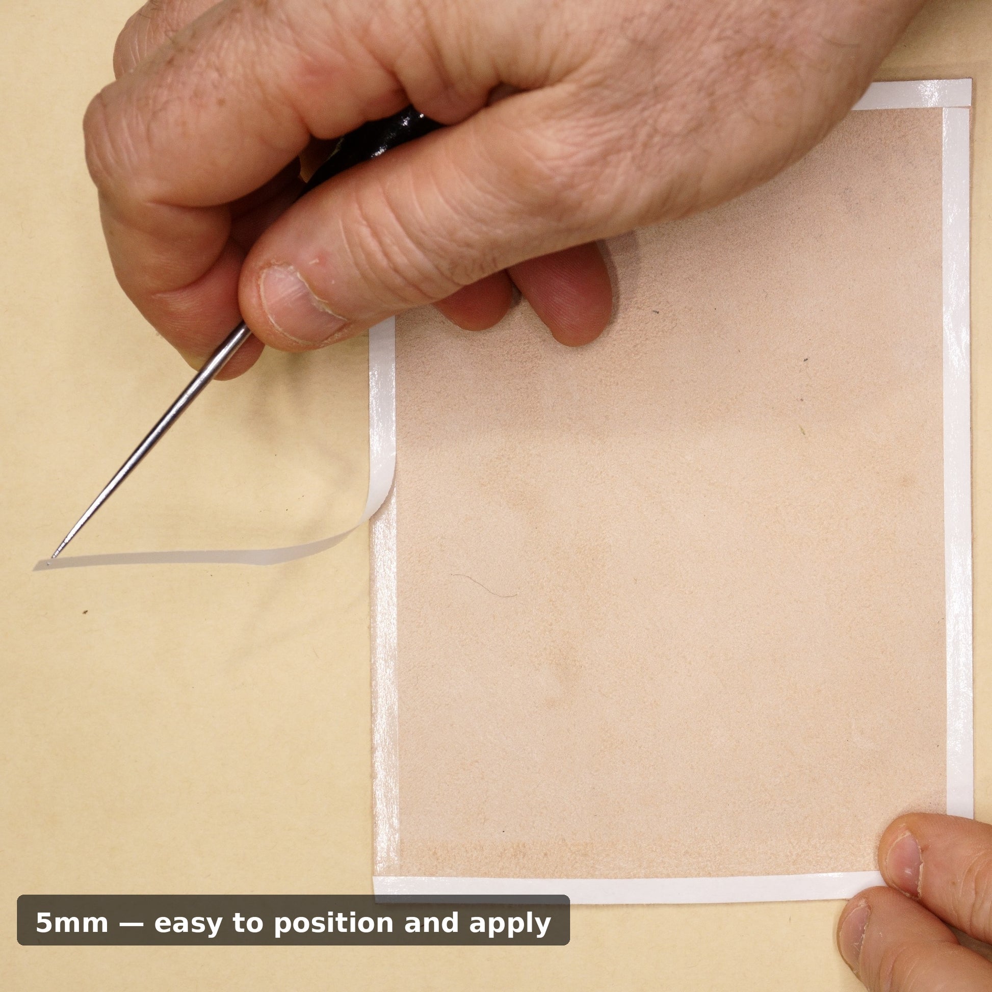Removing backing from 5mm double sided leathercraft tape with an awl