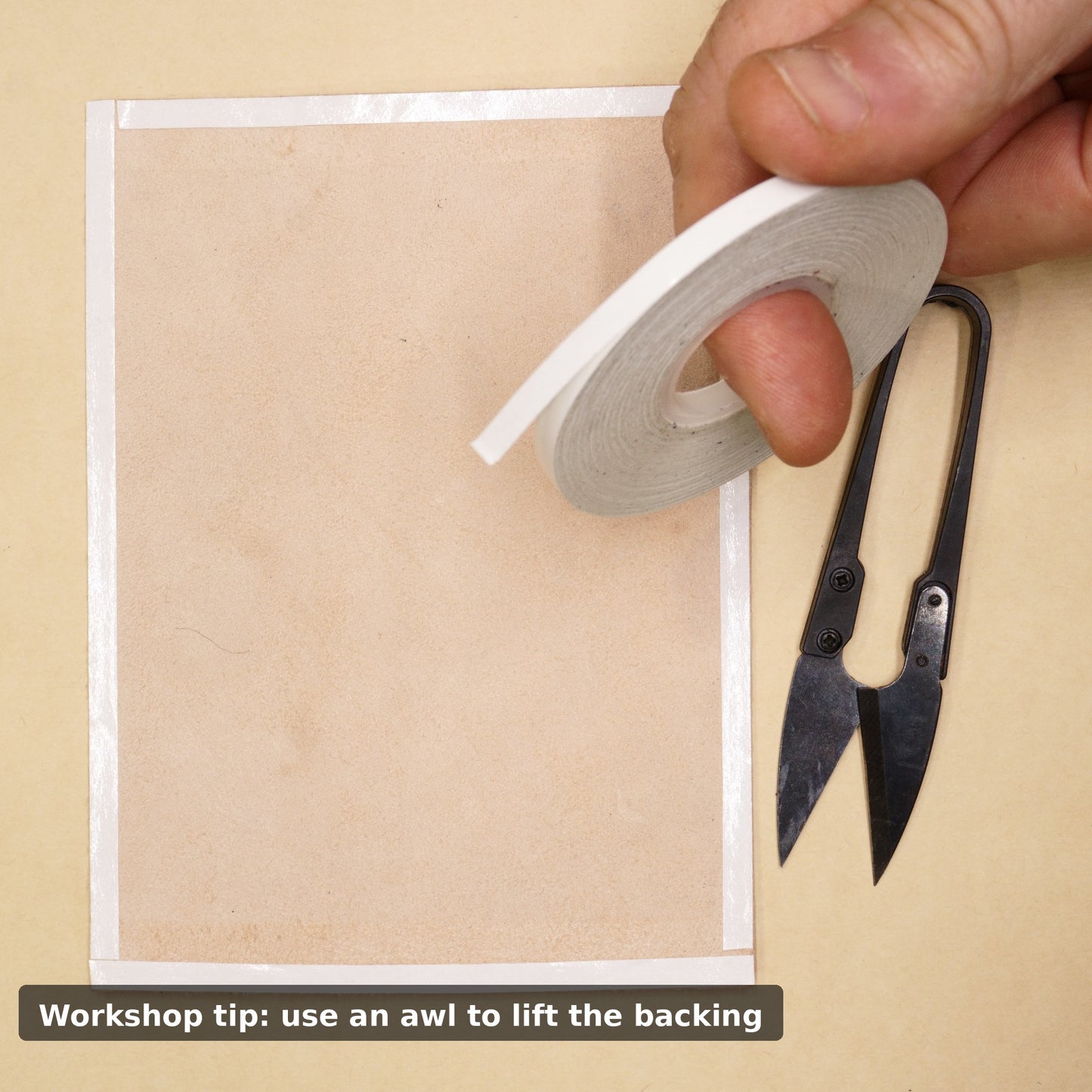 5mm double sided tape being applied to leather during wallet making