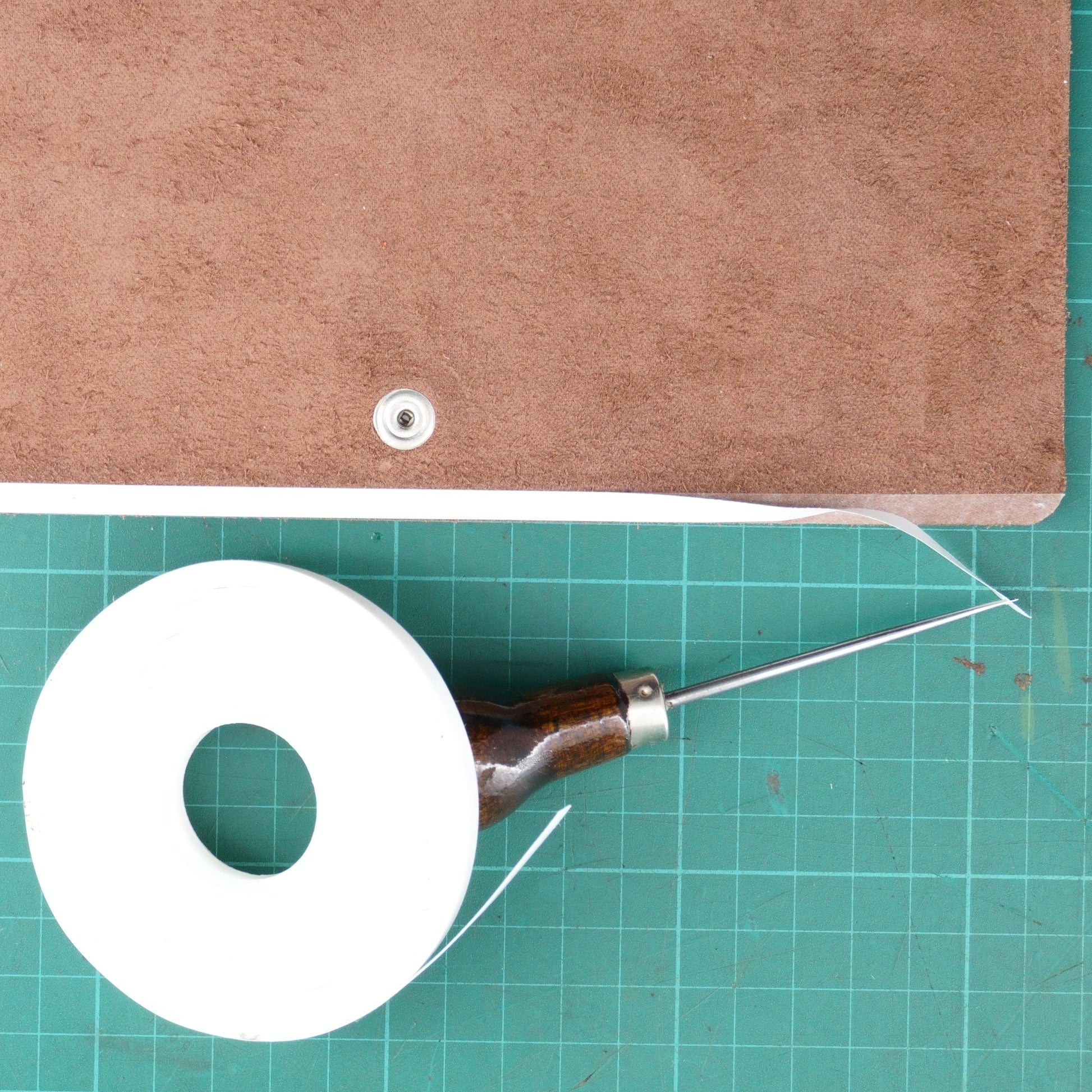Removing backing from 5mm double sided leathercraft tape with an awl